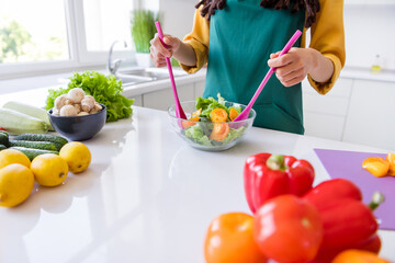 Photo of sweet charming dark skin lady wear yellow shirt cooking vegetable salad indoors room home house