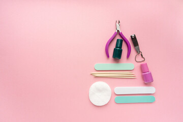 Christmas tree made of manicure and pedicure items on pink background, space for text