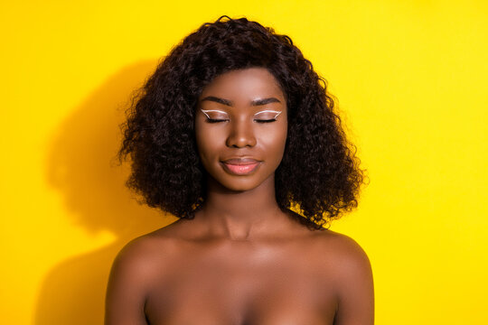 Photo of young beautiful charming dreamy peaceful afro woman wear no clothes isolated on yellow color background