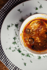 Close-up of a hodgepodge in a disposable paper cup. The concept of traditional food and foreign cuisine. Safe eco-friendly disposable tableware.