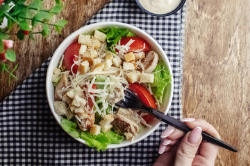 Salad in a disposable glass close-up. Healthy and fast food. Takeaway cafe. Disposable tableware for food safety. Healthy fast food