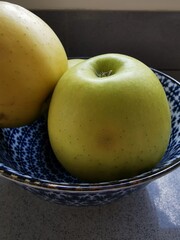 Apples in a blue plate.