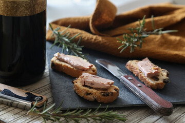 Foie gras and toasts on a rustic background