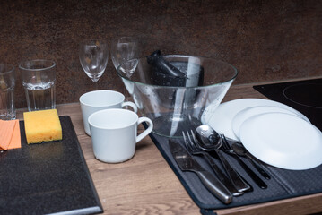 Kitchen interior, table with washed dishes and tableware