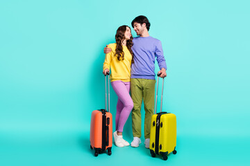 Full body photo of young couple happy positive smile hug travel fly bags airport isolated over teal color background