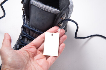 Hand holding paper tag label, copy space