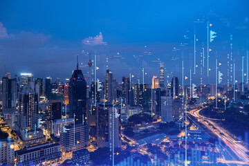 Stock market graph hologram, night panorama city view of Kuala Lumpur. KL is popular location to gain financial education in Malaysia, Asia. The concept of international research. Double exposure. © VideoFlow