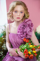 beautiful girl with tulips in pink dress fashion portrait. High quality photo