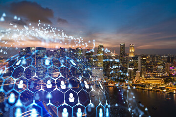 Glowing Social media icons on night panoramic city view of Singapore, Asia. The concept of...