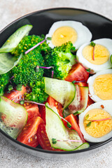 buddha bowl fresh salad boiled egg, broccoli, tomato, cucumber, vegetables meal snack on the table copy space food background rustic keto or paleo diet veggie vegan or vegetarian food no meat