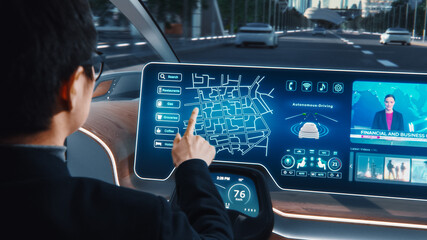 Futuristic Concept: Stylish Businessman Setting Location on an Interactive Navigation App on an Augmented Reality Dashboard while Sitting in an Autonomous Self-Driving Zero-Emissions Electric Car.