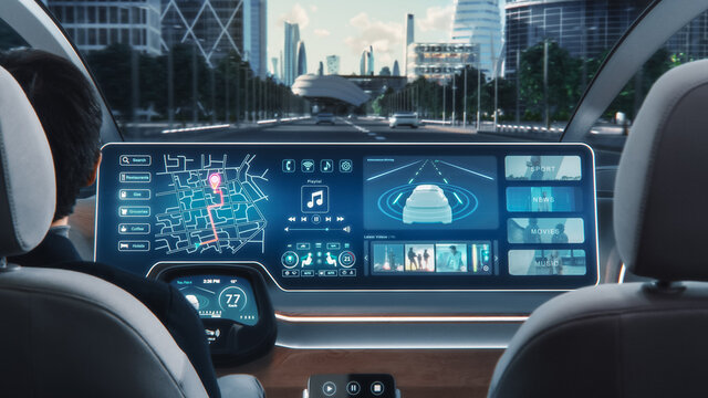 Futuristic Concept: Stylish Businessman Using Navigation App on an Augmented Reality Dashboard with Financial News Broadcast while Sitting in an Autonomous Self-Driving Zero-Emissions Electric Car. 