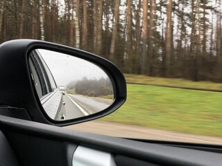 Obraz premium reflection of the road in the car mirror
