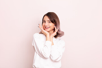 Portrait of a young girl model beautiful and natural with emotions in the studio