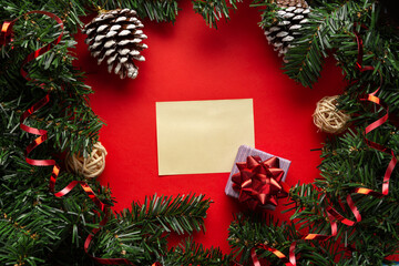 Christmas decorations with a gift box and empty space for congratulations or invitation. List of a present for new year's eve.