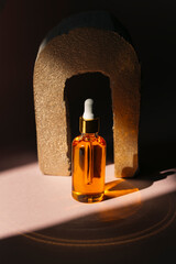 bottle of oil with essential oils on black background