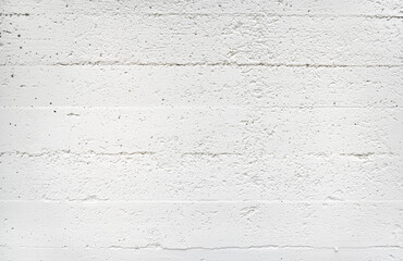 Concrete clean wall with horizontal stripes from the formwork painted white