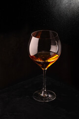 A glass of rose wine on a black background