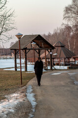 Russia. Spring. Morning. Sanatorium Lunevo. View from the house to the bank of the Volga with the rising sun and a stranger standing near the medical building.