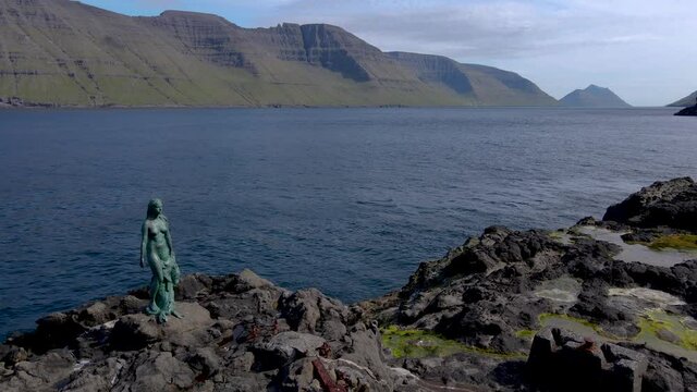 Beautiful cinematic aerial view of the mythical seal Woman in Mikladalur on the Faroe Islands