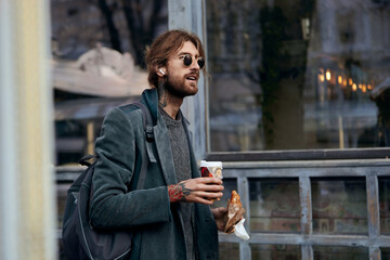 Fototapeta premium Male hipster with street food from snack point