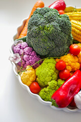 Fresh vegetables for vegan cuisine carrots, corn, cabbage, peppers, broccoli, tomatoes on a white background, copy space