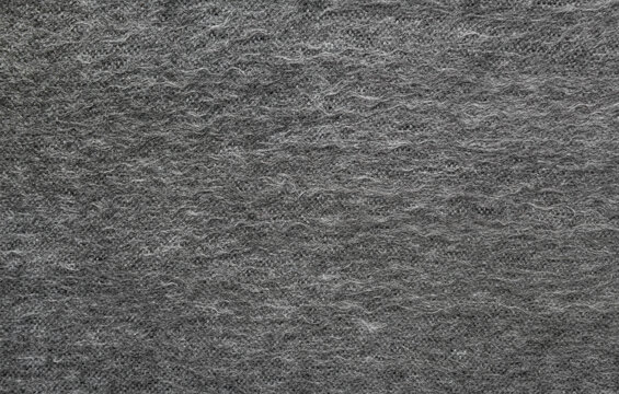Texture of gray woolen fabric with lint.