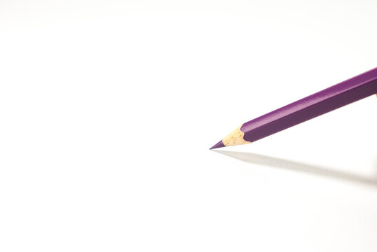 Colored pencils purple . Vibrant colors with  shiny arranged creatively on a white background.concept art design copy space school and office
