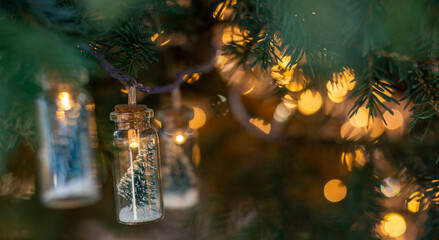Christmas garland on the branches of a fir tree, with a side of lights. A festive tradition. Selective focus.