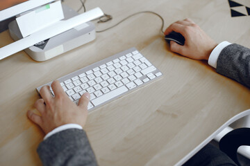 Hands of white collar worker typing