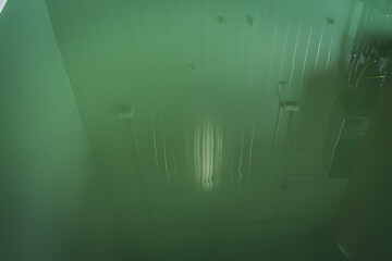 Fresh epoxy and waxed green floor newly applied in the industrial hall