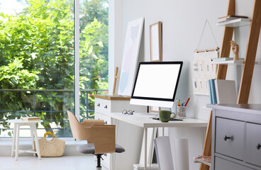Comfortable workplace with modern computer and stylish furniture in room. Interior design