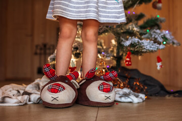 christmas slippers on the feet of a child. the concept of Christmas eve