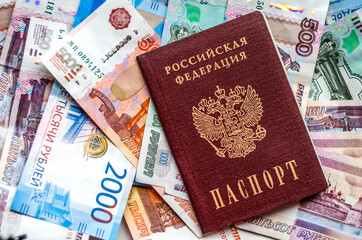 Russian passport lying on Russian money. The concept of finance, investment, savings and cash.