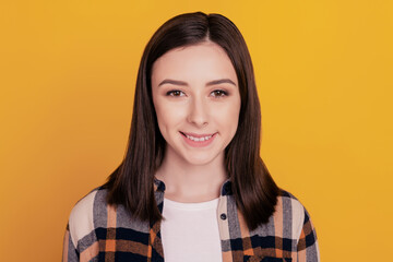 Fototapeta premium Photo of cheerful positive lovely cute lady look camera shiny smile isolated yellow color background