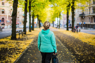 A woman walking in a park in Gothenburg downtown, Sweden