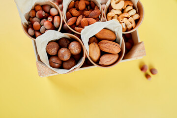 Assorted nuts in box nuts: pecan, almond, macadamia, brazil, cashew, hazelnut, Rich in minerals and protein. Healthy nutrition, high in zinc, magnesium and vitamins, online ordering, shoping concept.