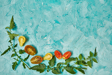 Flat lay Pattern composition with fresh ripe tomatoes on blue background with copy space,  Tasty and healthy food, top view.