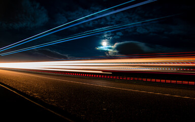Fototapeta na wymiar lights of cars with night. long exposure, moon and sky