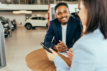 Female seller consulting diverse couple about car purchase