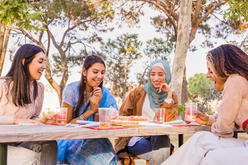 Christmas celebration multiracial group on a table. millennial diverse group eating roscon de reyes