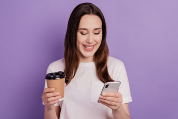 Fototapeta premium Photo of young girl look read browse cellphone read morning news drink latte isolated over violet color background