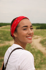 Portrait of beautiful young woman smiling outdoors