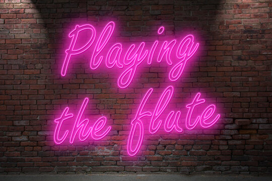 Neon Playing the flute (in german Griff der Kleopatra) lettering on Brick Wall at night