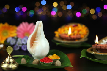 Vermilion Roli Sindoor, Turmeric Haldi On Betel Paan Leaves And Shell Shankh. Clay Oil Lamp Diya, Deep Or Dia Lit In Background. Theme For Diwali, Navratri Pooja, Dussehra Puja And Shubh Deepawali