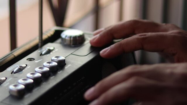 Close Up hand with mustache and mullet from the 70s 80s 90 listens to his music using a portable walkman cassette player. Vintage concept.