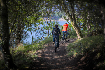 two men cycling along the coast