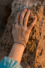 Closeup of female hand wearing fancy chain bracelet