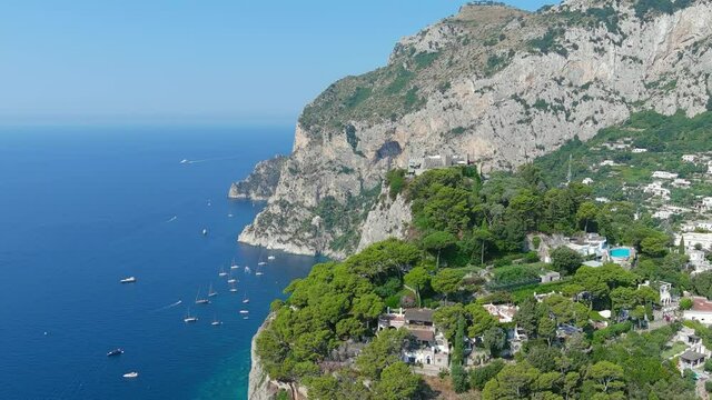 Capri, Italy: Aerial view of famous Italian island near Naples, southern part of island, lot of boats and yachts moored near Marina Piccola - landscape panorama of Europe from above