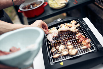 Preparing barbeque on a electrical modern grill outdoors.